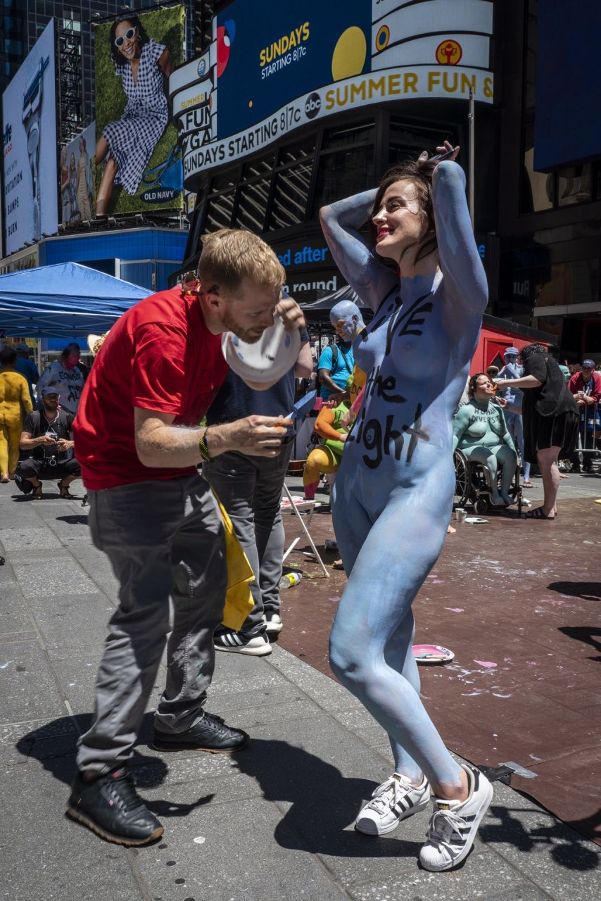 Protesters strip, get painted in Times Square