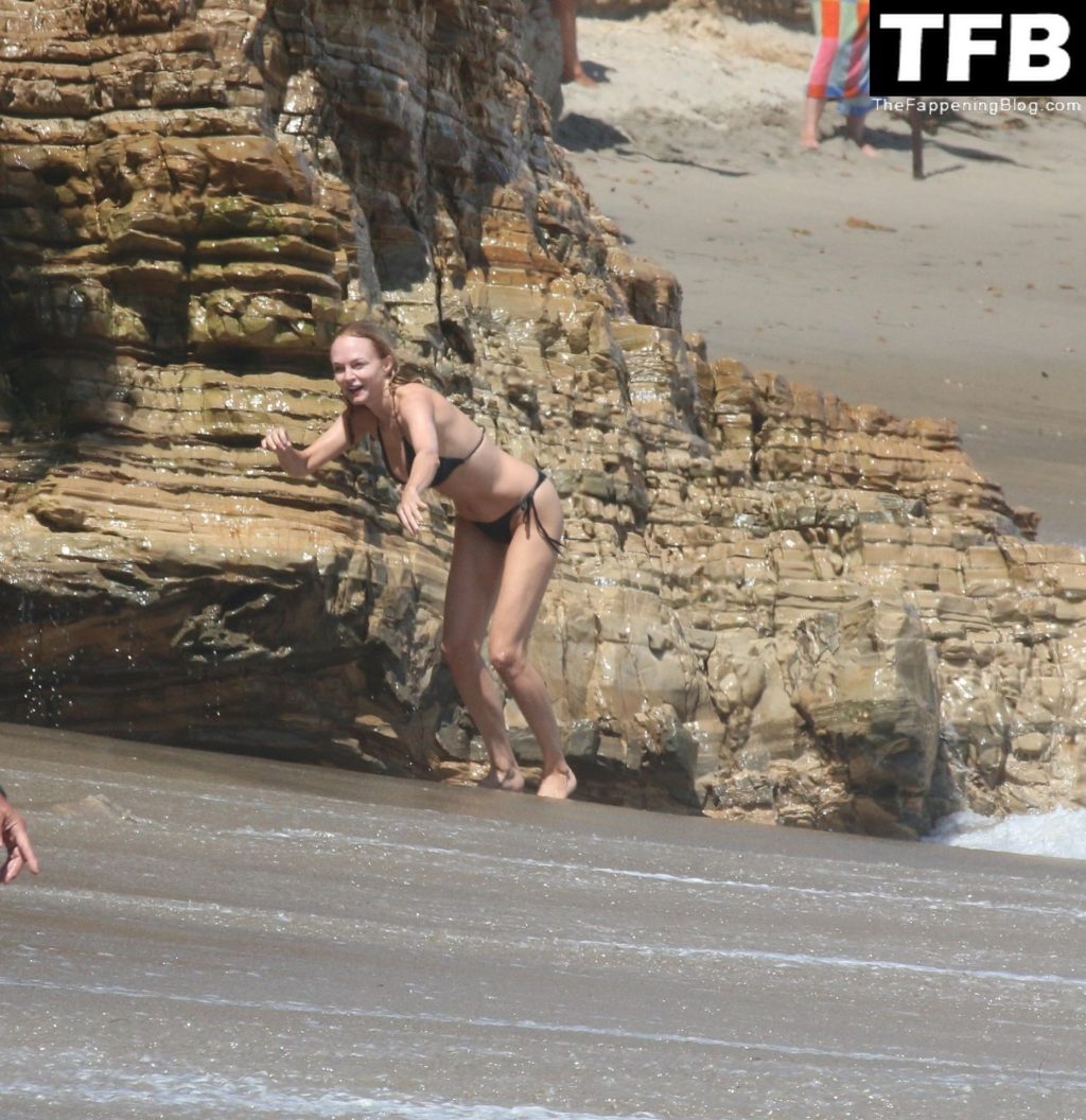 Heather Graham Slips Into A Black Bikini For A Beachside Frolic Next To