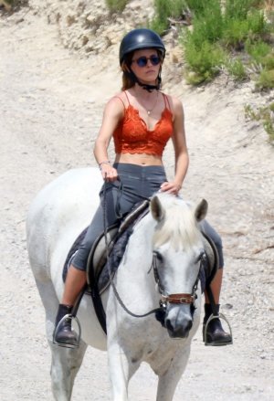 emma-watson-in-orange-bralette-enjoys-horseback-riding-in-ibiza-2022-2.jpg