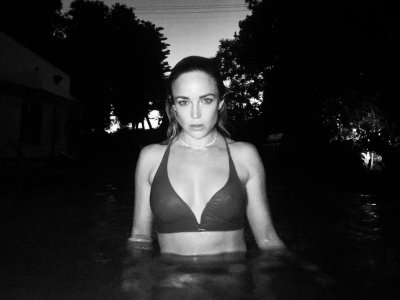 Caity Lotz - wearing a bikini top 152401368_caity-2.jpg