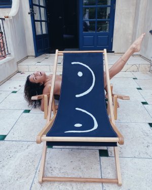 Meaghan Rath - posing behind some boob chairs.jpg