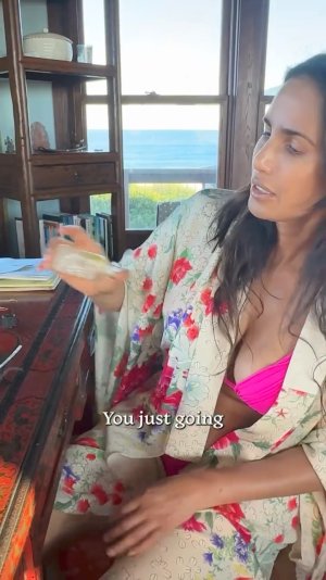 Padma Lakshmi making essential oil in bikini ME153FJ9_o.jpg
