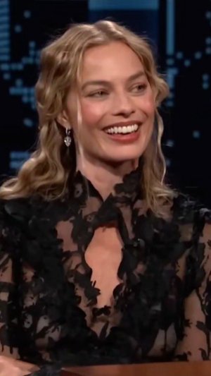 Margot Robbie in a lace little black dress 27.jpg
