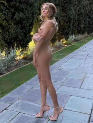 Margot Robbie in a white minidress1 faake.png