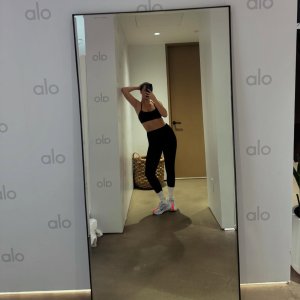 Bailee Madison - taking a selfie in a mirror at a gym.jpg