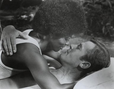 Gloria Hendry on top of Roger Moore - Live and Let Die - 1972.jpg