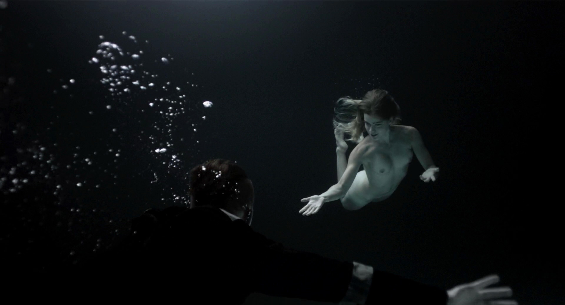 Lisa (Gemita Samarra) swims fully nude toward... 