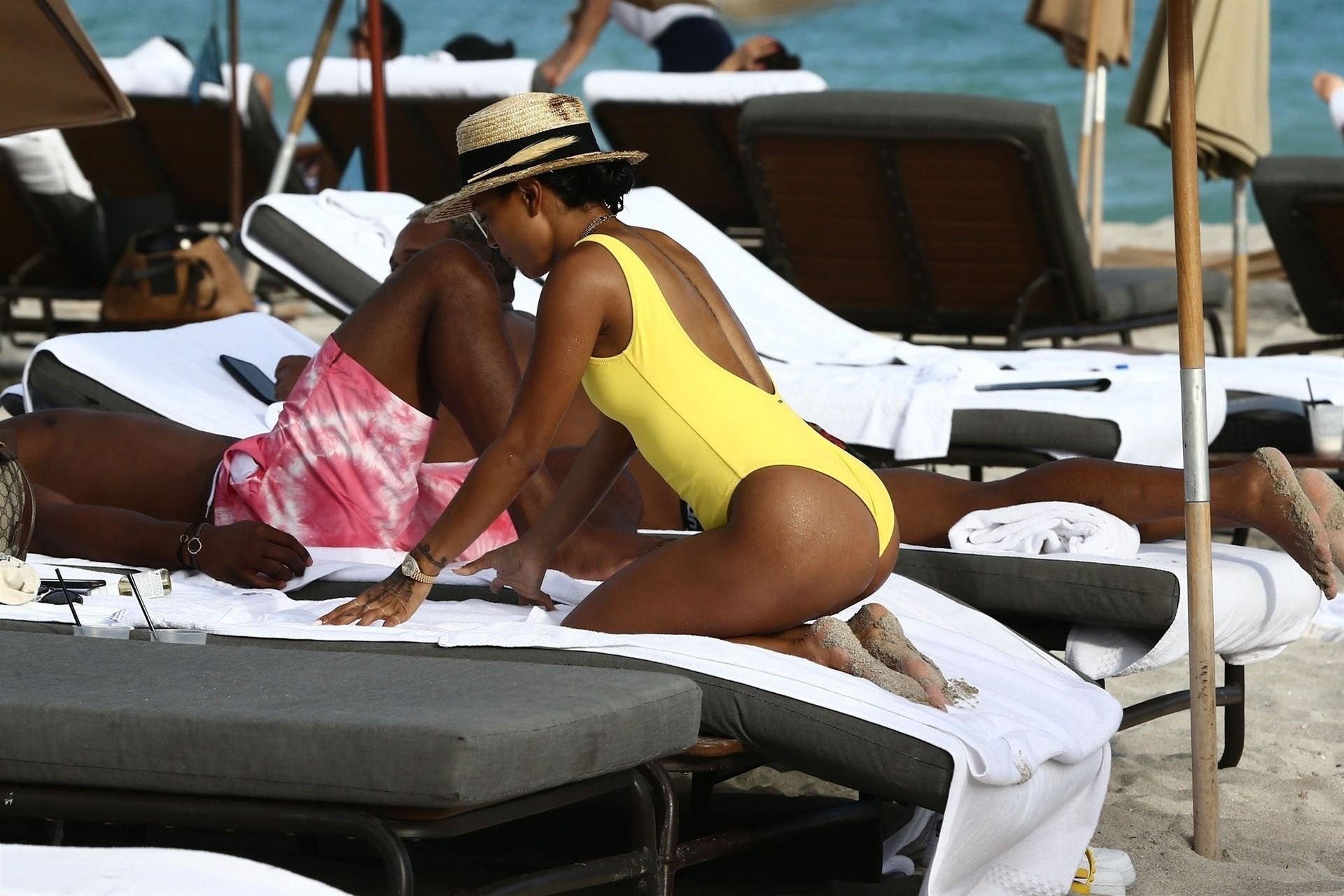 Karrueche Tran shows off her curves in a bright yellow swimsuit during a be...