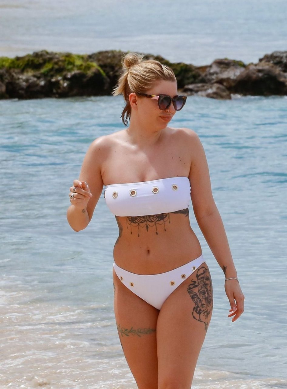 Olivia Buckland is spotted showing her tattooed body in a tiny white bikini...