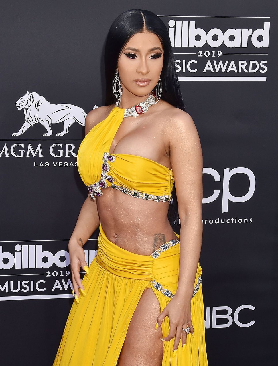 Cardi B wows in a yellow dress on the red carpet kissing with Offset at the...