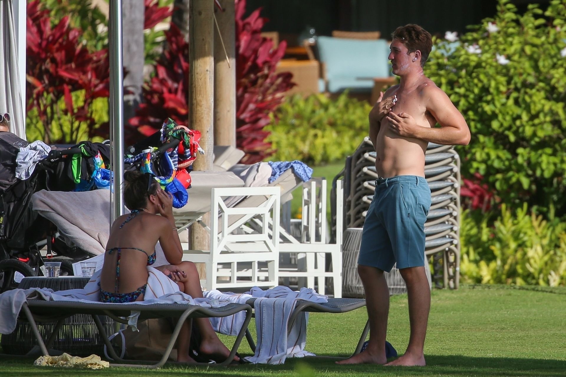 Miles Teller and his fiance Keleigh Sperry pack on the PDA poolside in Maui...