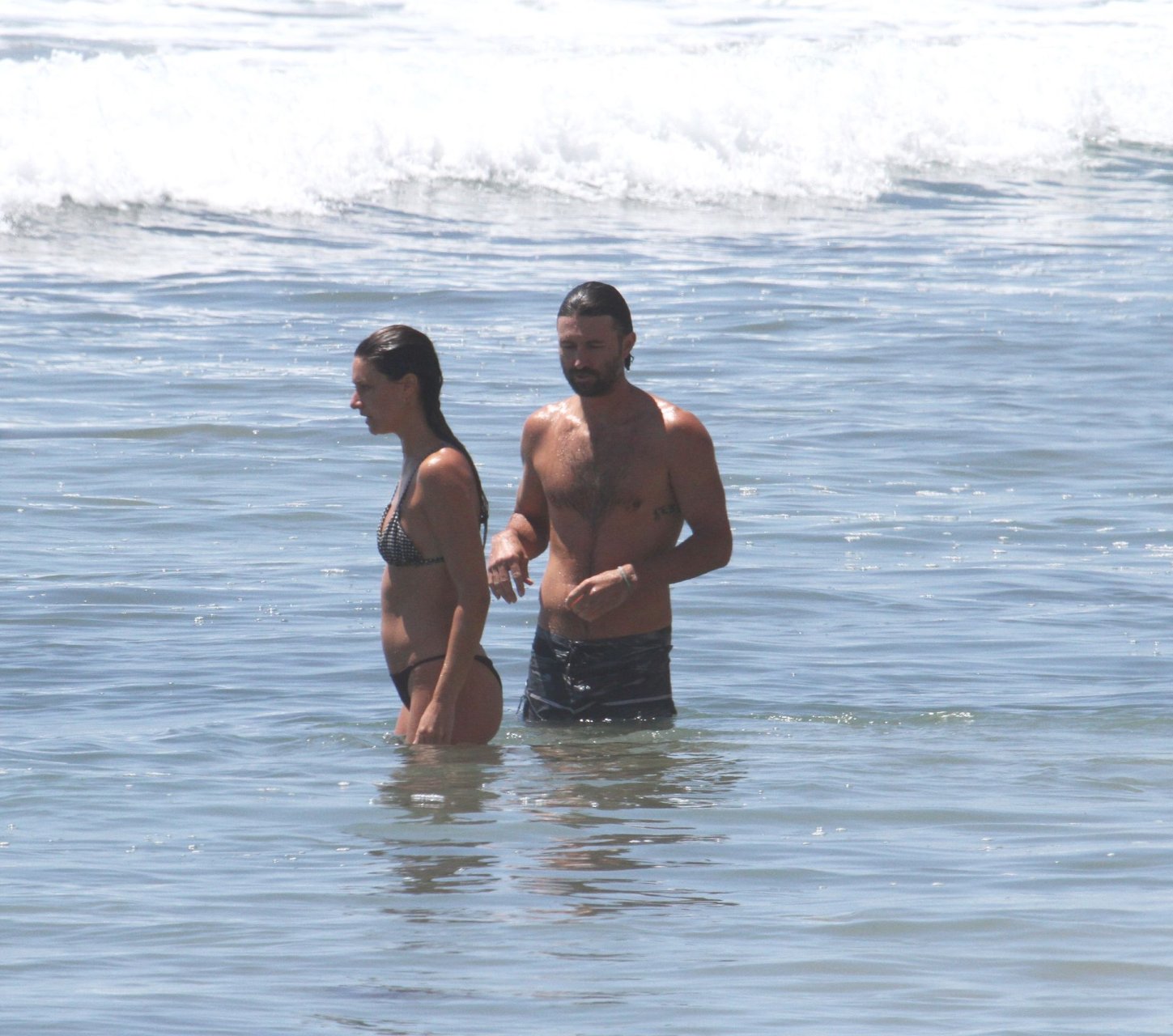 Brandon Jenner shirtless swimming in the ocean with a pregnant girlfriend, Cayley...