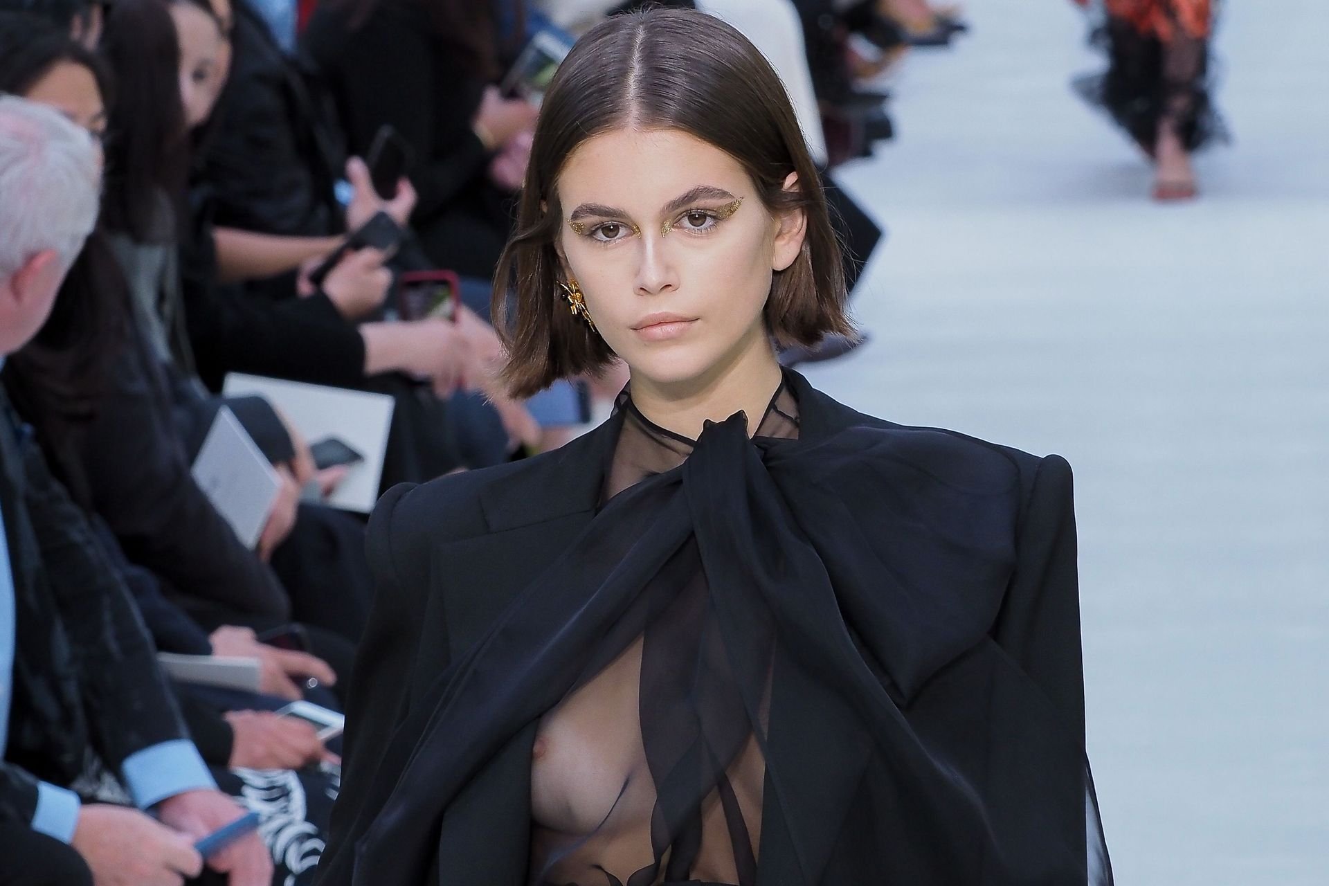Model Kaia Gerber (18) walks the runway in a see-through blouse at the Vale...