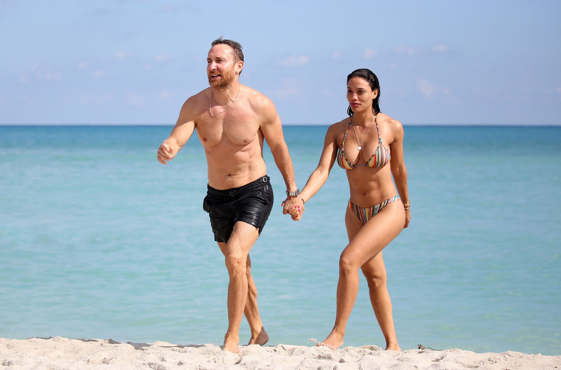 DJ David Guetta and girlfriend Jessica Ledon show off their beach bodies an...