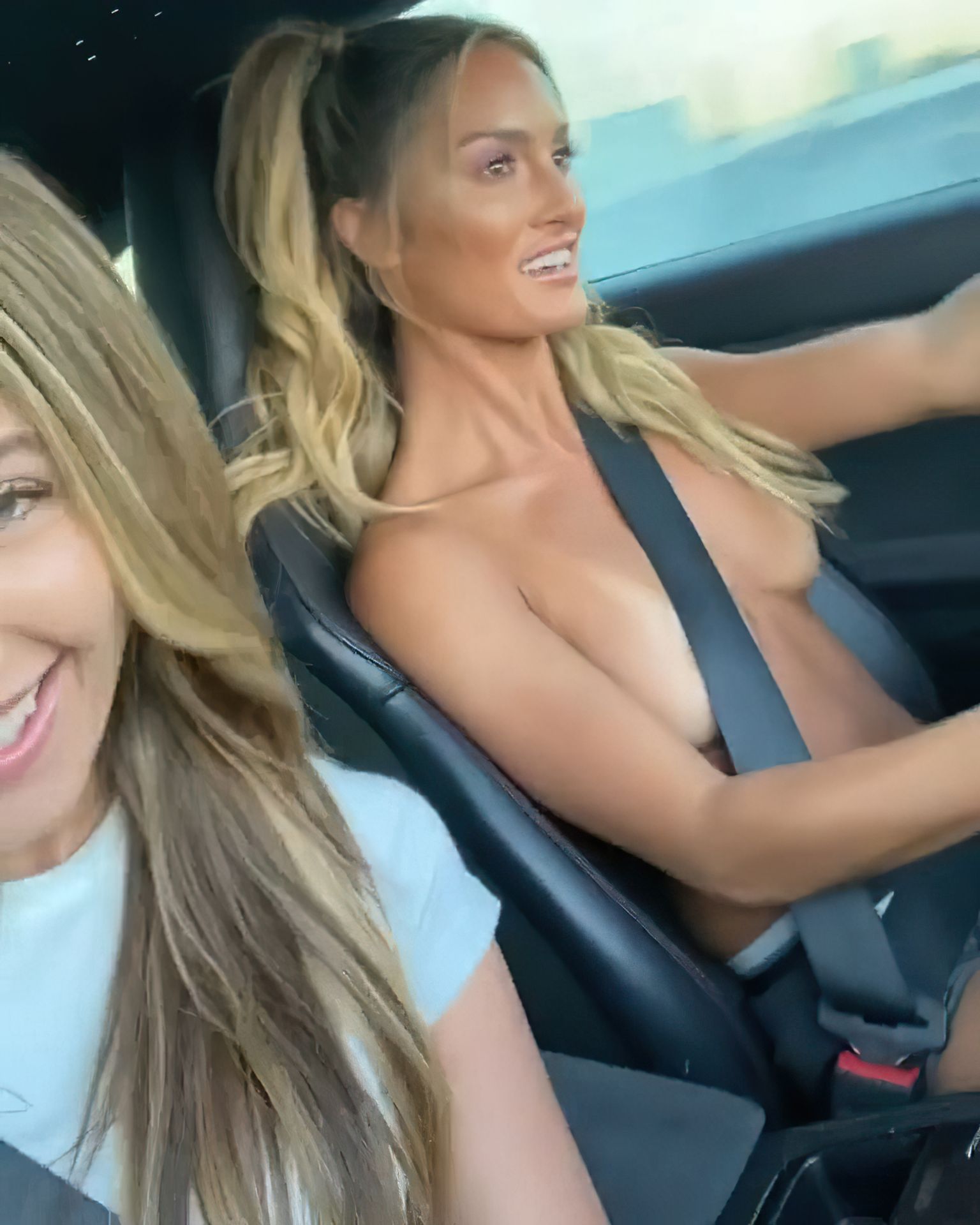 Model Julia Rose slightly covered her nude boobs while driving topless with...