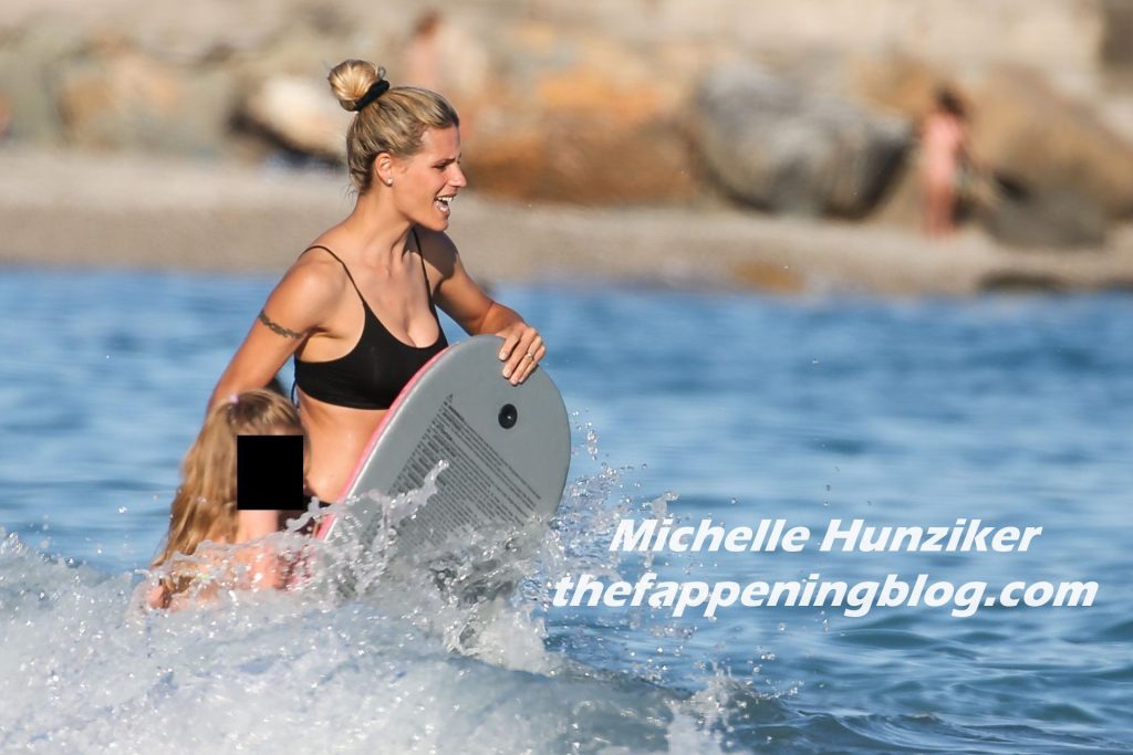 Michelle Hunziker Enjoys a Day on the Beach with Her Family (13 Photos)