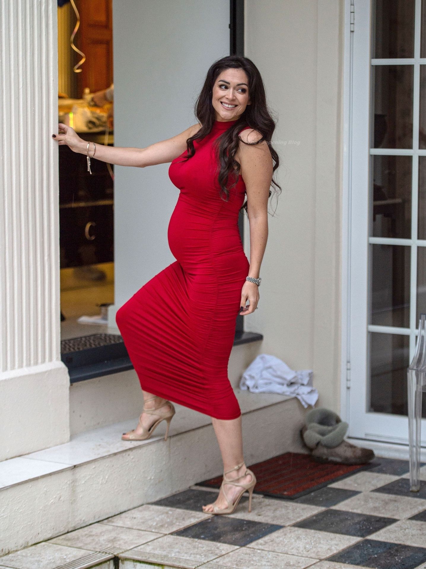Casey Batchelor Shows Off Her Baby Bump In A Red Dress