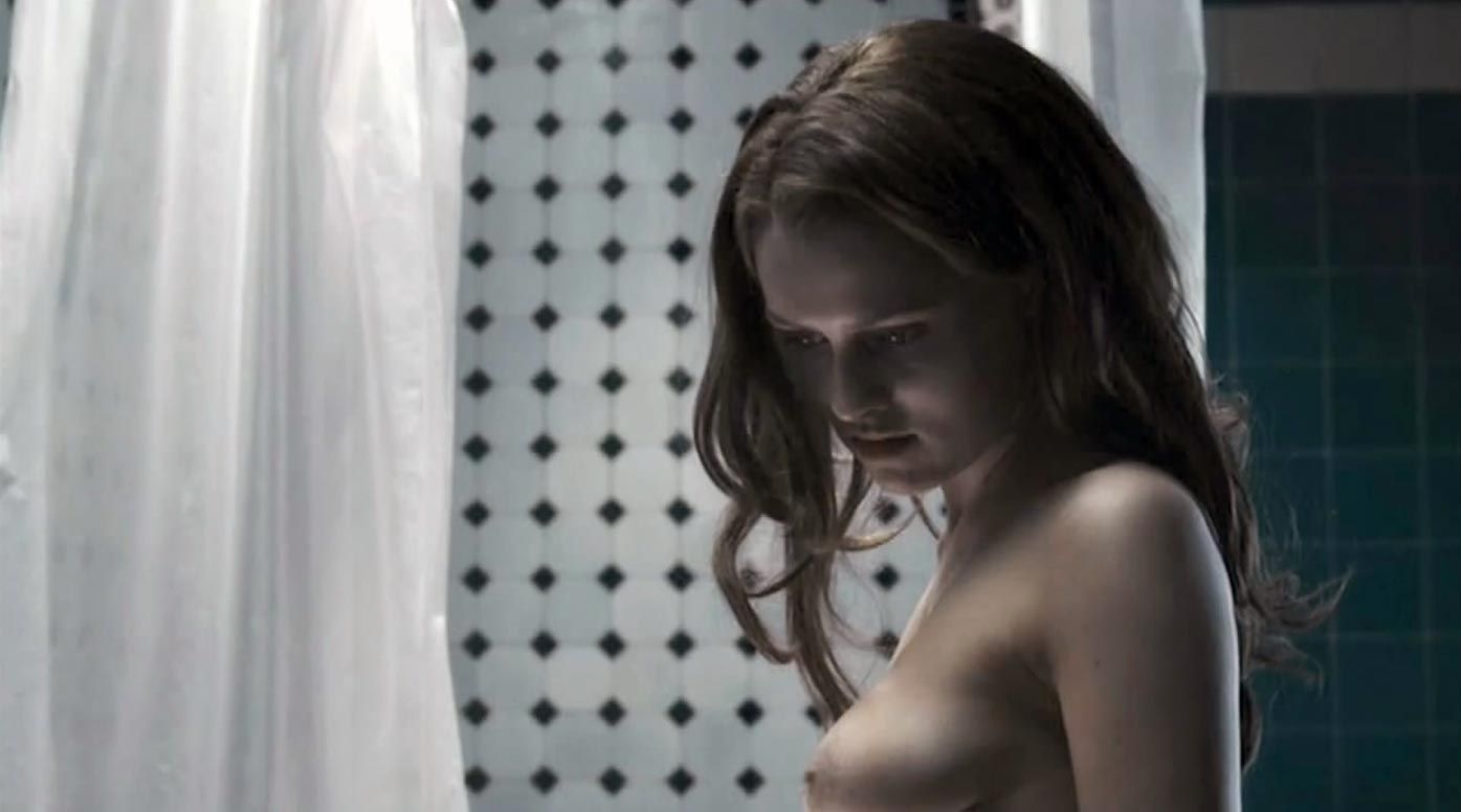 Teresa Palmer is topless in bed with a man, exposing her breasts while they...