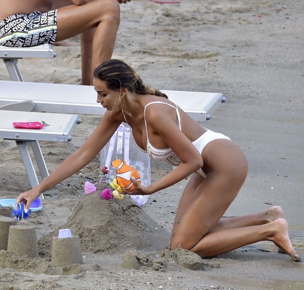 Busty Madalina Diana Ghenea Enjoys Her Time at Paraggi Beach (32 Photos) [Updated]