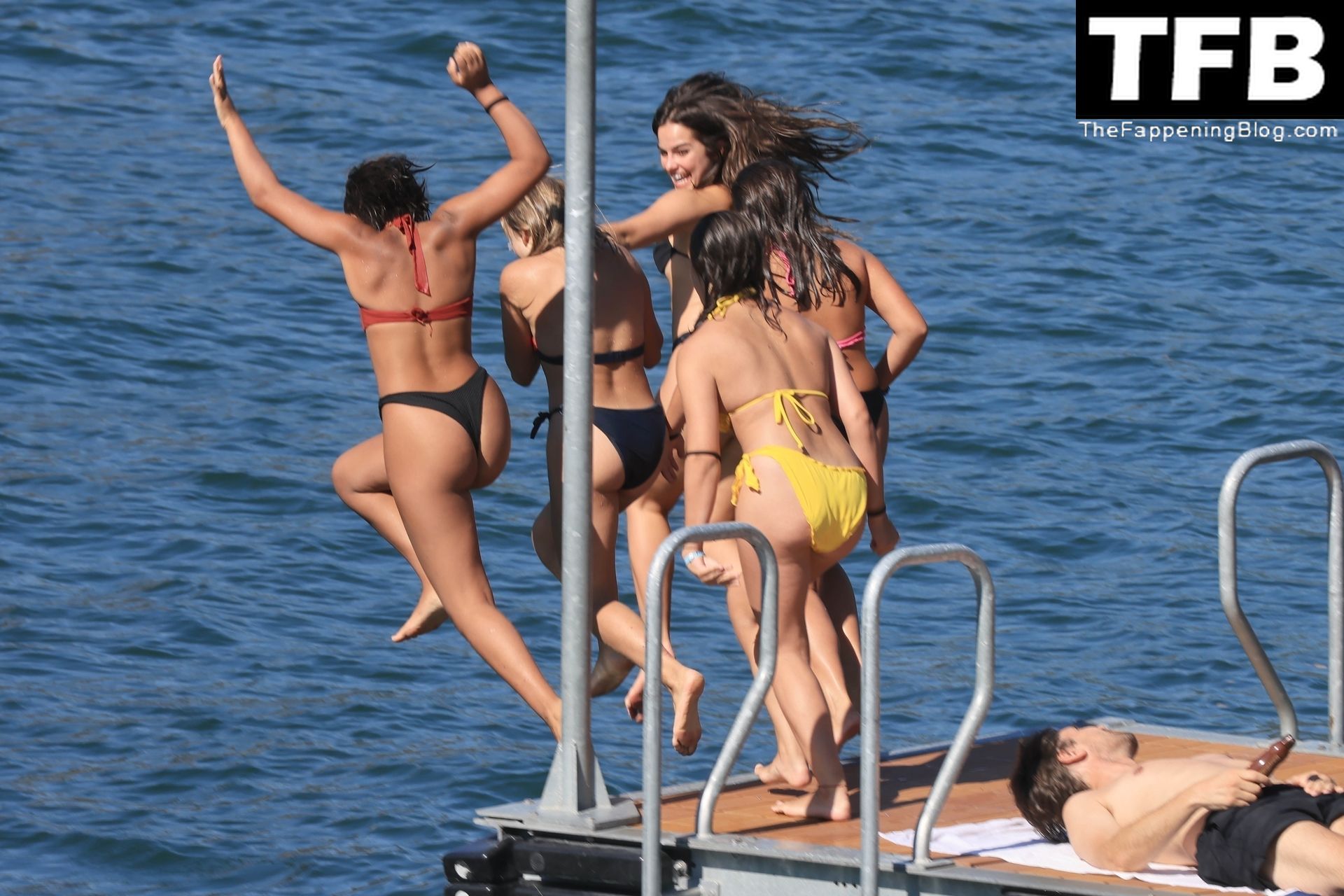 TikTok star Addison Rae is seen diving into Lake Como with fans after being...