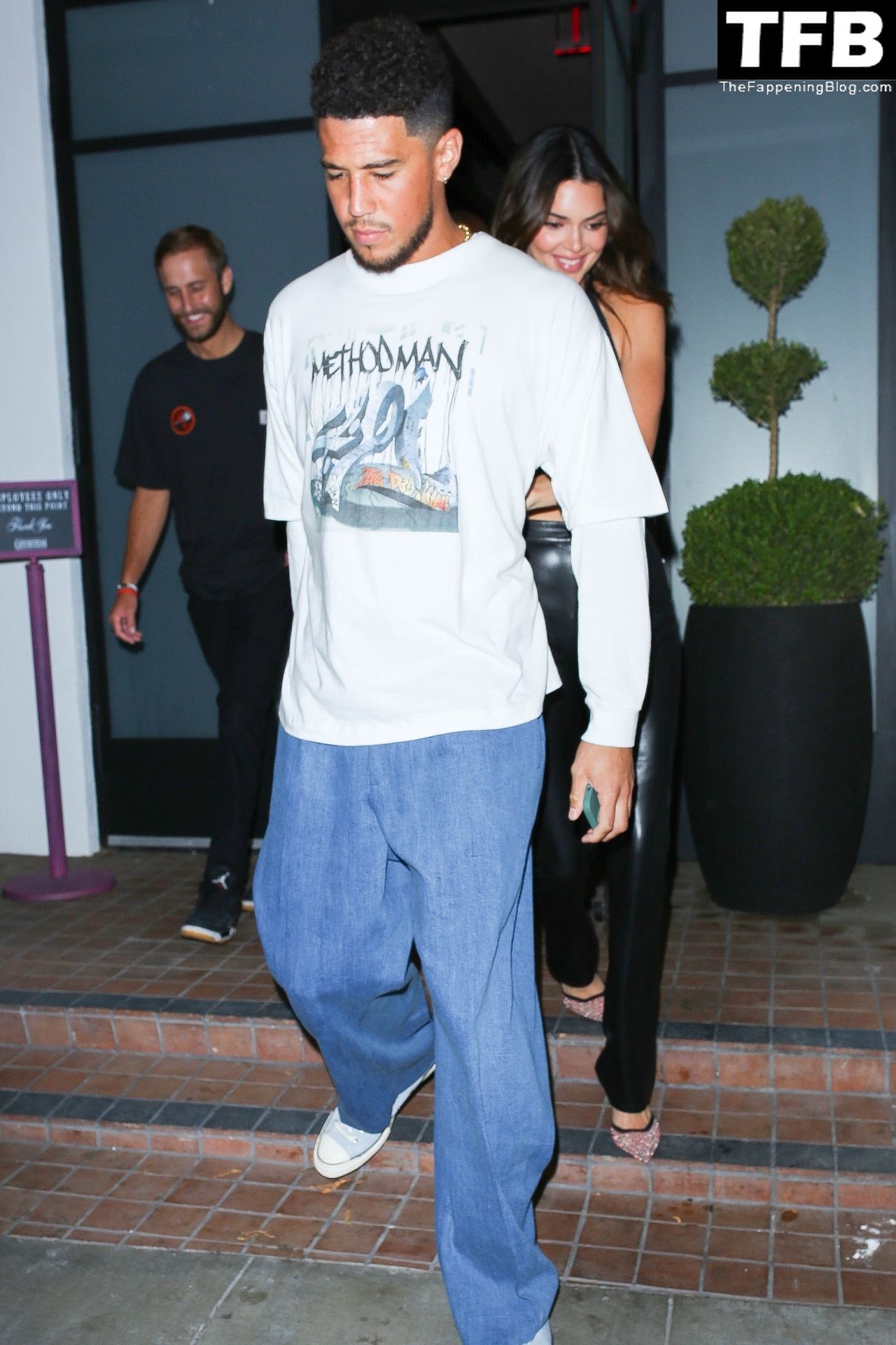 Kendall Jenner and her boyfriend Devin Booker are surrounded by security as...