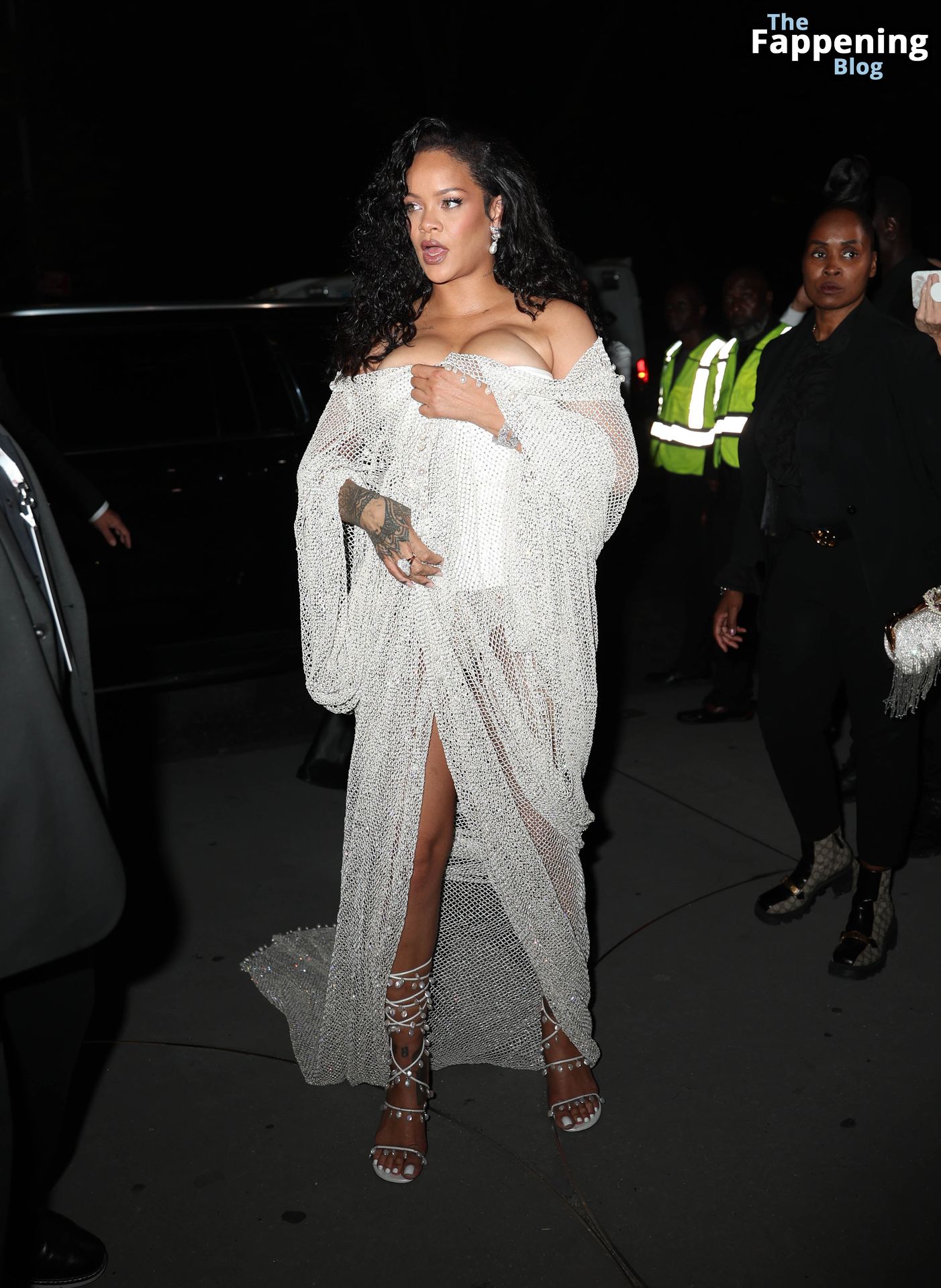 Rihanna Displays Her Curves in a White Dress (13 Photos)