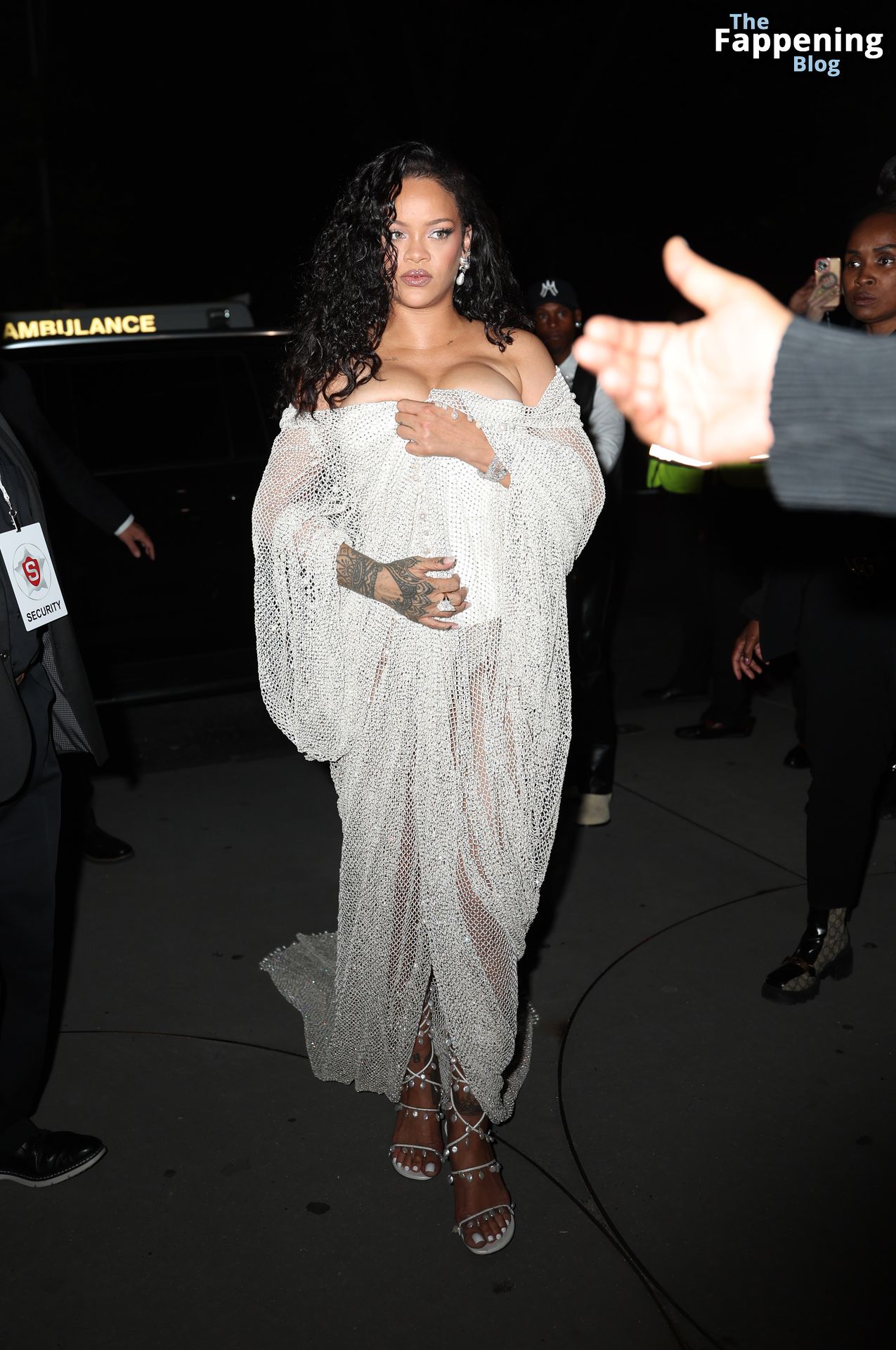 Rihanna Displays Her Curves in a White Dress (13 Photos)