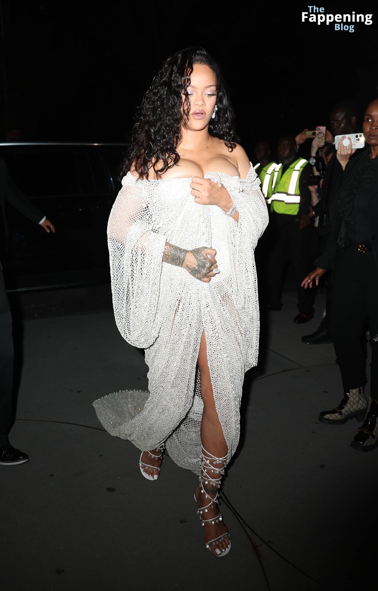 Rihanna Displays Her Curves in a White Dress (13 Photos)