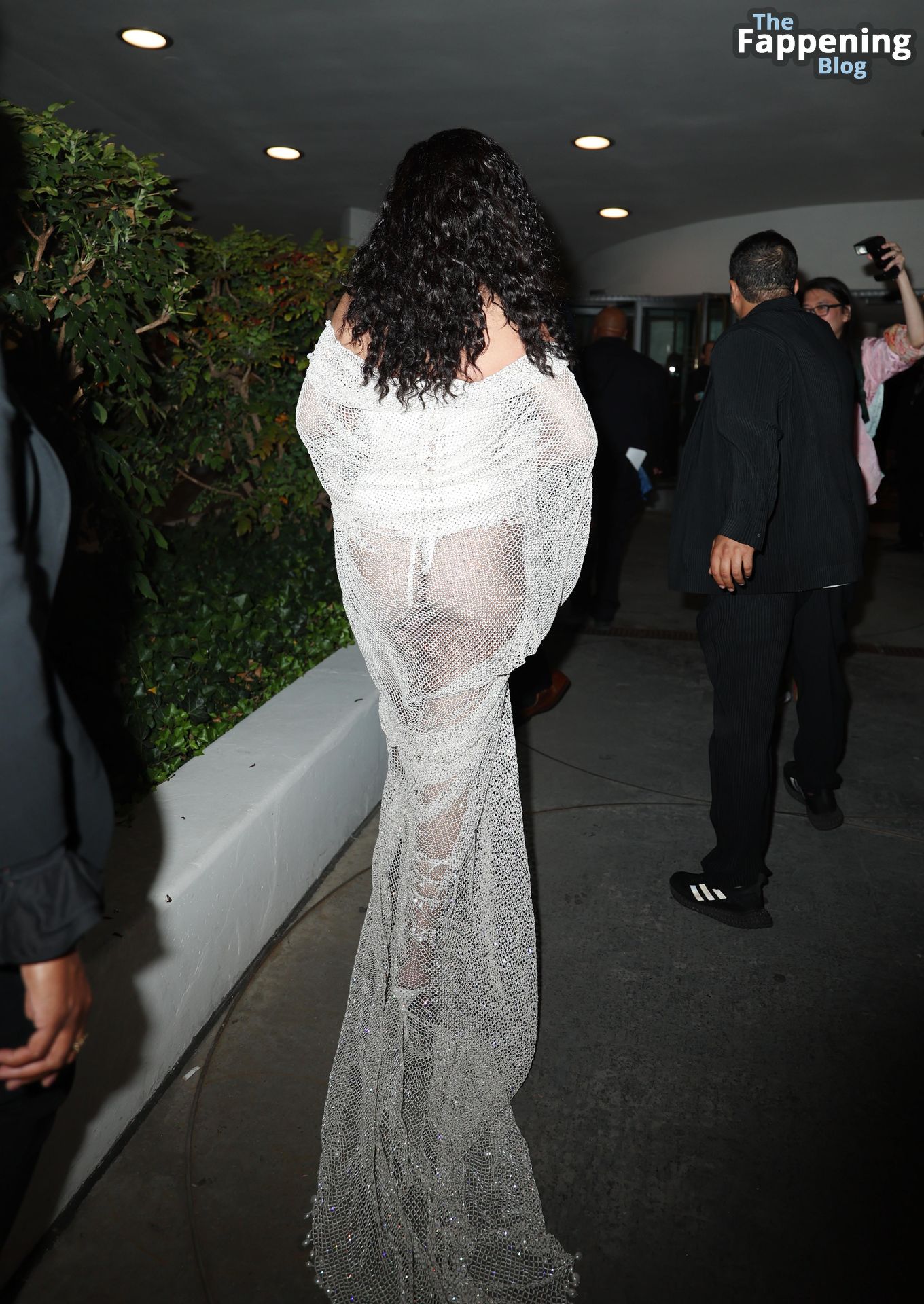 Rihanna Displays Her Curves in a White Dress (13 Photos)