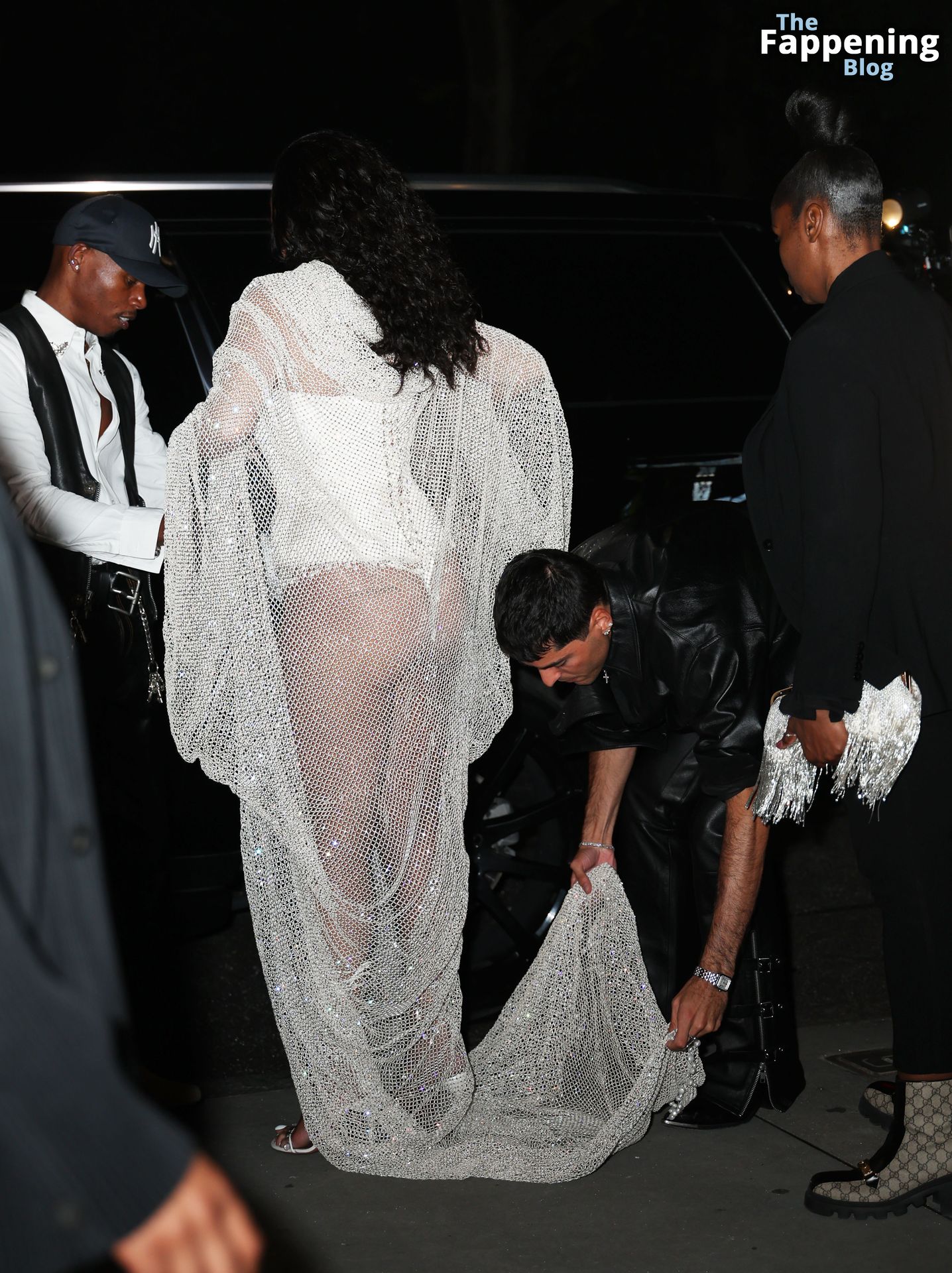 Rihanna Displays Her Curves in a White Dress (13 Photos)