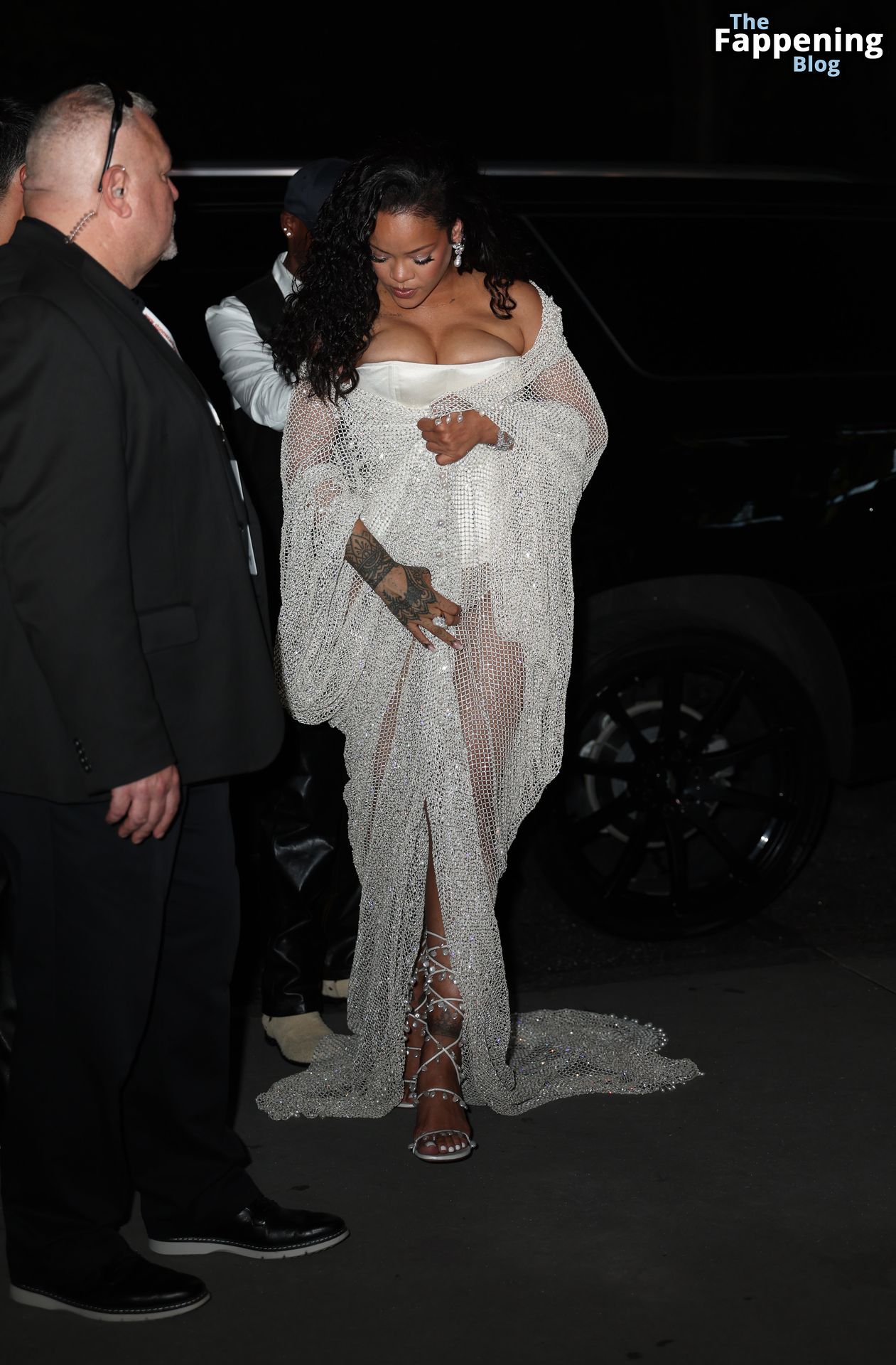 Rihanna Displays Her Curves in a White Dress (13 Photos)