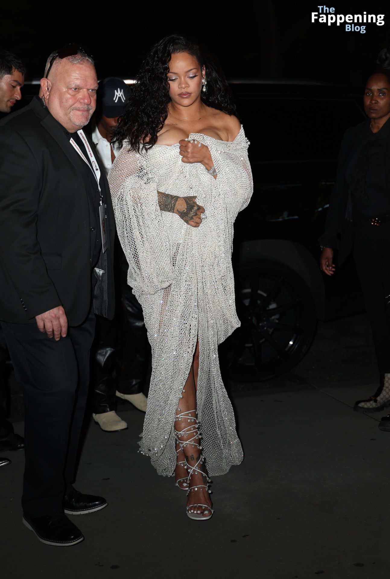 Rihanna Displays Her Curves in a White Dress (13 Photos)