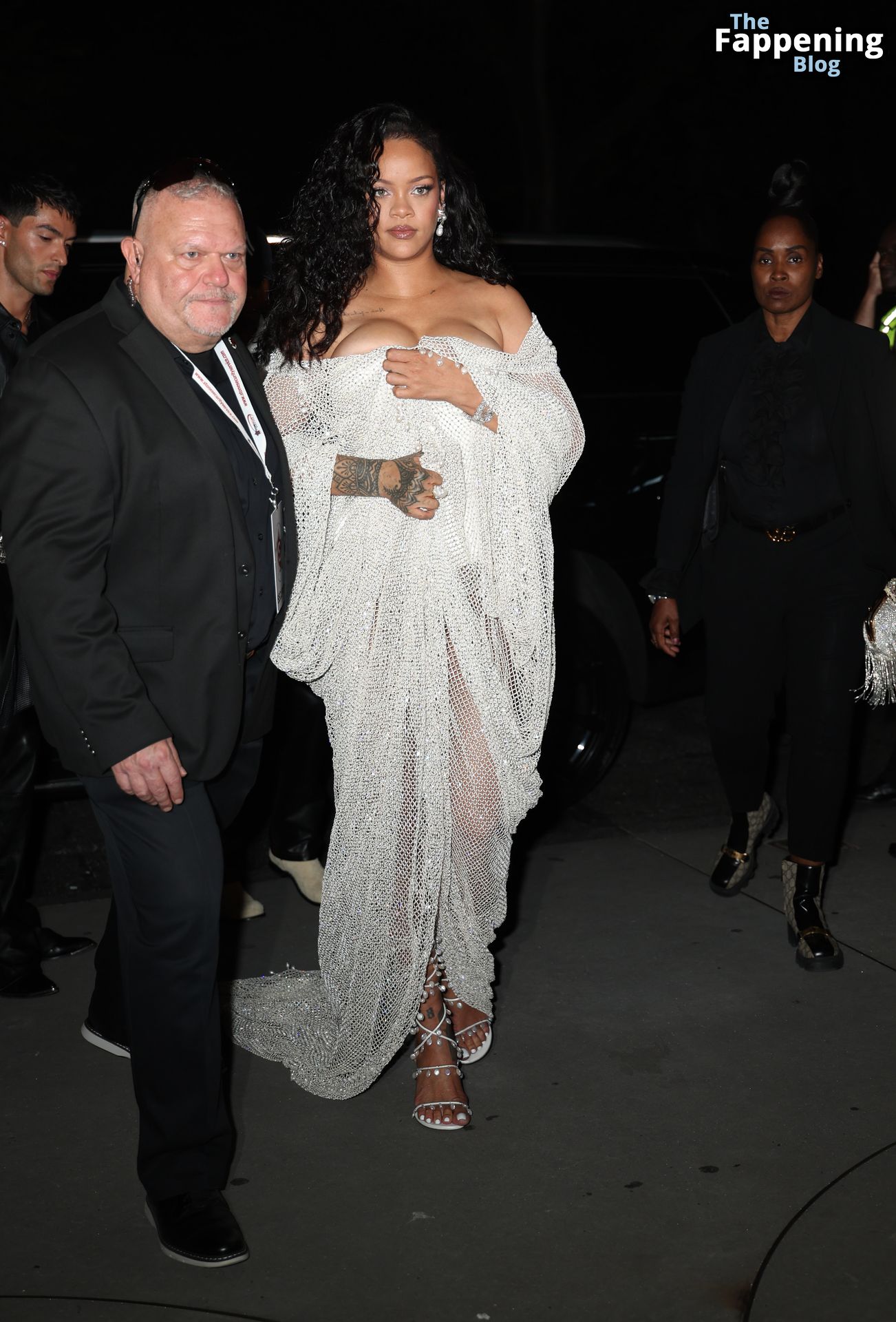 Rihanna Displays Her Curves in a White Dress (13 Photos)