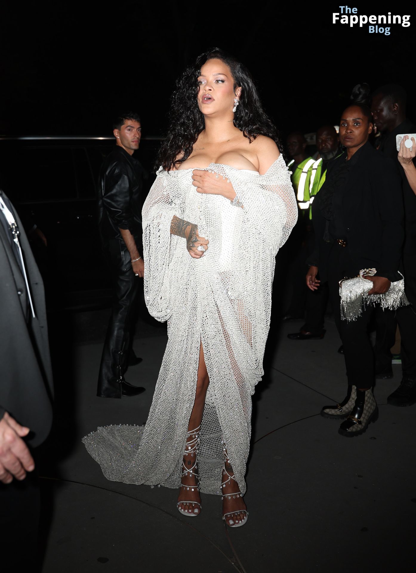 Rihanna Displays Her Curves in a White Dress (13 Photos)