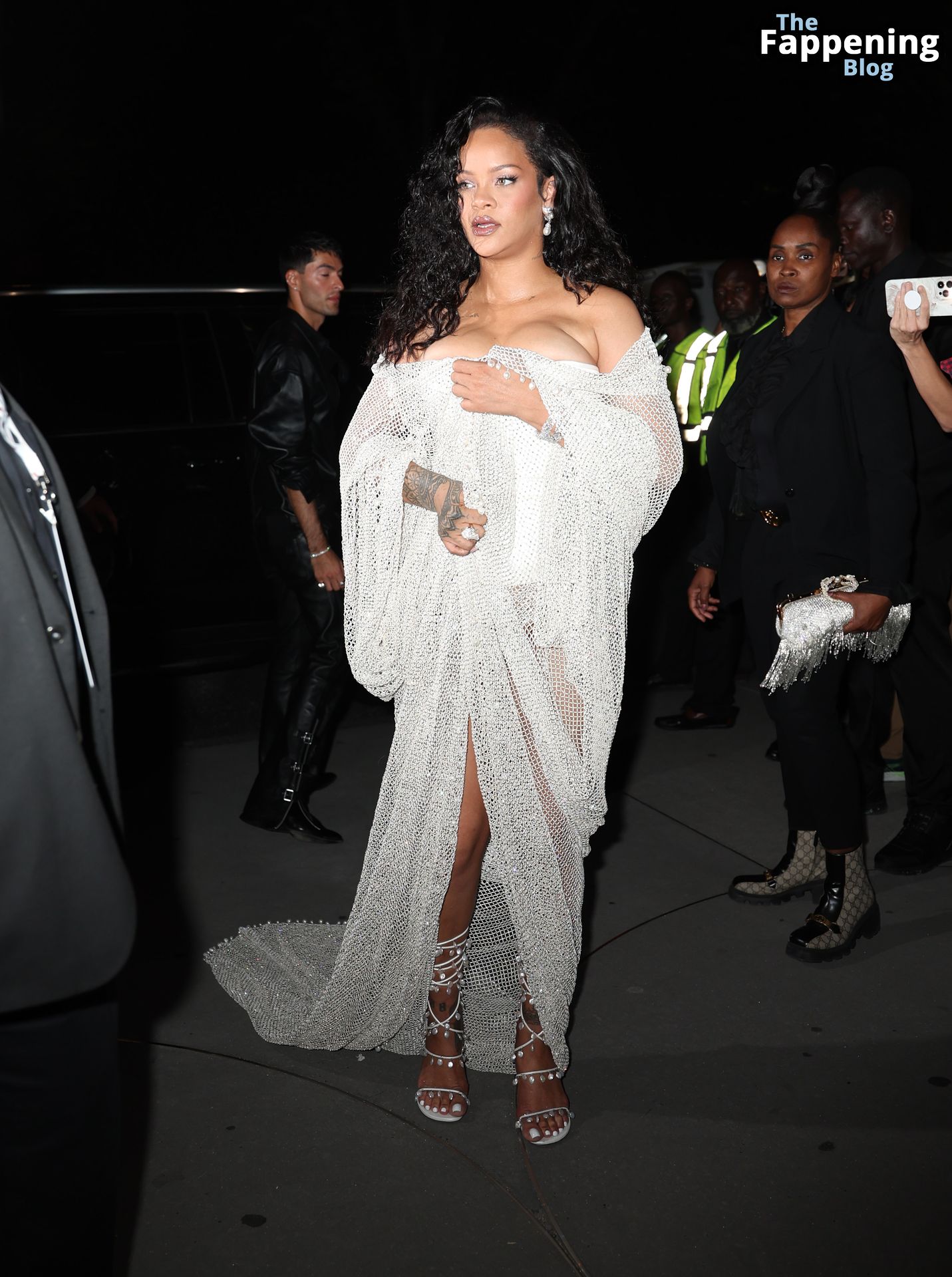 Rihanna Displays Her Curves in a White Dress (13 Photos)