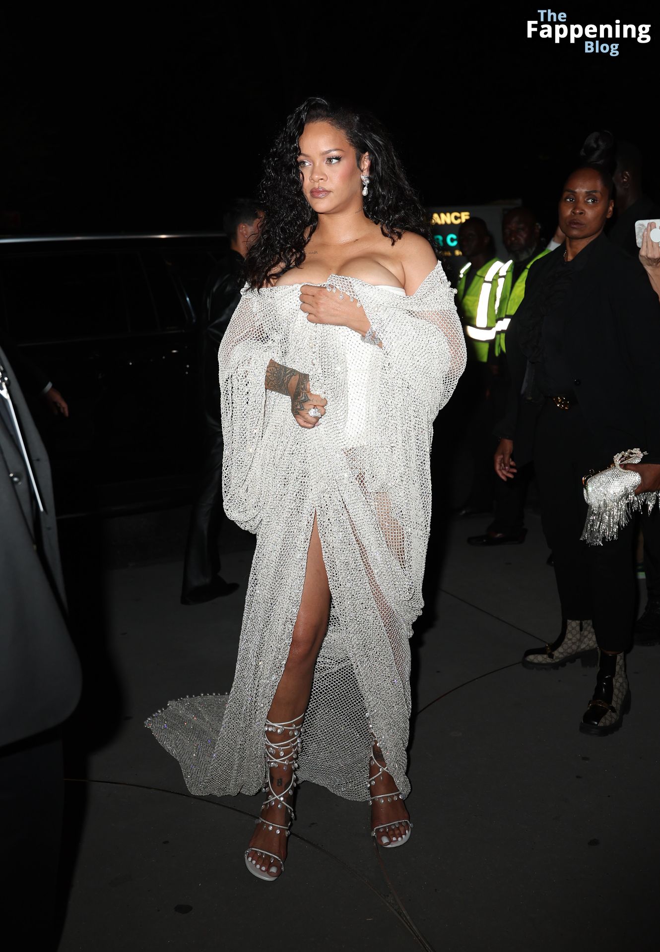 Rihanna Displays Her Curves in a White Dress (13 Photos)